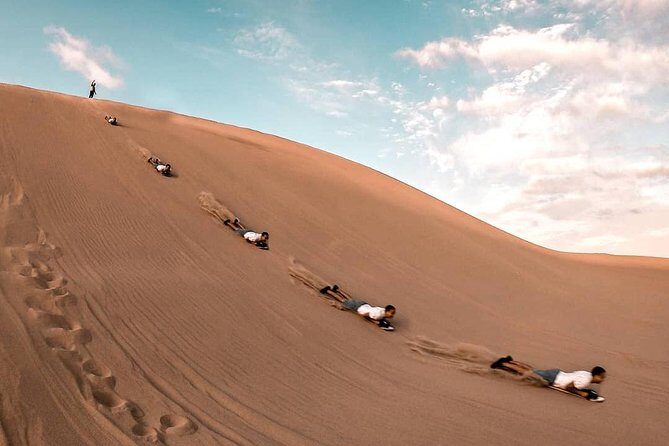 Premium Paracas & Huacachina Day Trip from Lima with Sunset Toast - Sunset toast and the ride back to Lima: movies, Wi-Fi, and late-night drop-offs
